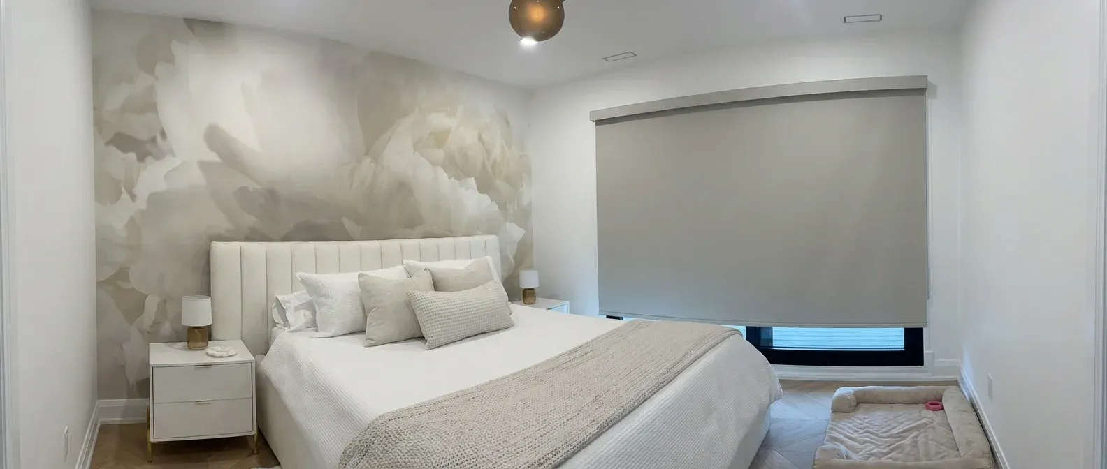 Custom taupe blackout roller shade installed in a luxury bedroom